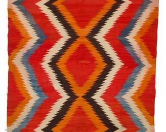 17
A Navajo Transitional blanket
Late 19th/early 20th century, Diné
Woven in red, cream, orange, pale blue, and black wool, with three conjoined serrated diamonds
88" H x 50" W
Estimate: $800 - $1,200