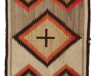 10
A Navajo Ganado rug
Early 20th century, Diné
Woven in red, cream, ochre, natural tan and grey, and black wool, with central cross motif and floating serrated diamonds
88" H x 43.5" W
Estimate: $1,000 - $1,500