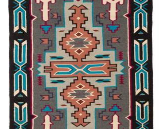33
A Navajo Teec Nos Pos rug
Late 20th century, Diné, Daisy King
Woven in grey, black, blue, maroon, salmon, and cream wool, depicting an elongated stepped diamond with central X-form motif and feathers, and elaborate X-form border
59.5" H x 41.5" W
Estimate: $700 - $900