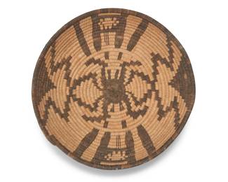 157
A Southwest pictorial spider basket
Mid-20th century
A coiled basketry tray with stepped spider and zigzag motifs to center
2.5" H x 9.75" Dia.
Estimate: $200 - $400