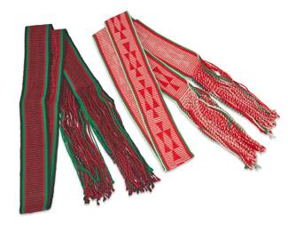 284
Two polychrome Navajo woven sash belts
Mid/late 20th century, Diné
Each sash belt or 'Sis'lichíí' woven in a ribbed stacked diamond pattern with a long fringe to each end, one in black, red, and green yarn and one in white, red, and green yarn
2 pieces
Each 97" L including fringe; Black: 3.5" H; White: 4" H
Estimate: $100 - $200