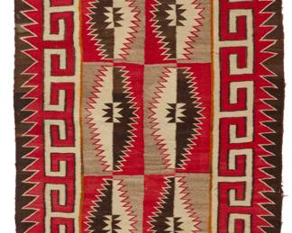 21
A Navajo Red Mesa rug
Mid-20th century, Diné
Woven in red, cream, black, tan, and light grey wool, with six serrated diamonds within hooked and sawtooth borders, with two tan spirit lines
61.5" H x 42" W
Estimate: $1,000 - $1,500