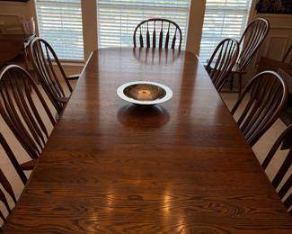 This gorgeous oak table has four leaves and extends to 108 inches X 42 inches X 28 inches tall. There are 10 chairs.