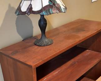 Wooden bookshelf and stained glass lamp