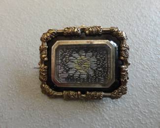 Victorian Mourning Brooch - this one appears to have fabric inside but they were made to commemorate deceased loved ones.Frame and backing made of pinchbeck (brass alloy made to resemble gold)