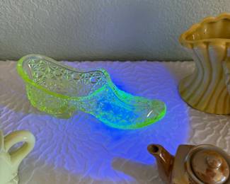 Charming assorted vintage decorative objects collection featuring a polished brass candelabra, a miniature ceramic tea set, a yellow glass shoe figurine, and several additional novelty and figural décor pieces.