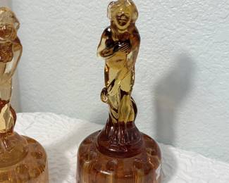 Lot #58 Art Deco “Bashful Charlotte” Amber Glass Flower Frog Pair – Coordinating Yet Different Figural Design apx 6" Tall