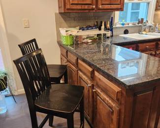 4 black painted mid-height barstools