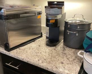 Ninja Air fryer, Keurig with paperwork and Cuisinart pots and pans .