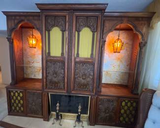 Vintage entertainment center with a built in bar, 8 track tape player and record player, with a working faux fireplace. With built in lighting, plenty of storage and shelf space, this unique piece is sure to make a statement. 