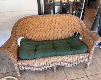 Outdoor wicker set in good condition. Full set includes a live seat, two chairs, and a small two tier table.