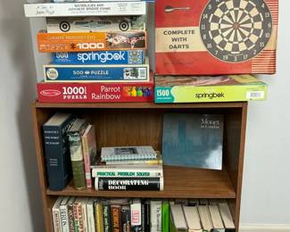 Bookcase with Books, Jigsaw Puzzles, and Vintage Dart Game