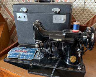 Singer Featherweight 221 sewing machine with carrying case and original instruction manual
