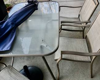 PRE-SALE ITEM - Glass & Metal Outdoor Table is 5 feet Long x 38 inches Wide x 29 inches Tall it’s rectangle shaped $80, 4 Chairs $50 umbrella $50 OR ALL for $150.