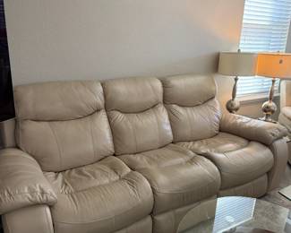 Leather 3-seat reclining sofa. Sold  and priced "as is"; tear on left armrest. Otherwise in great condition. 