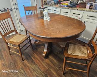 view of the beautiful Oak dining table with 4 chairs, has two leaves 