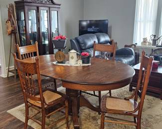 Full view of the dining room table with chairs, has another extra leaf. 