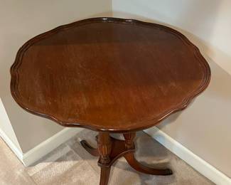 F64 - $60. Vintage Pie Crust Table. Solid Wood - very good condition. Measures 24" across x 27.25" tall. 