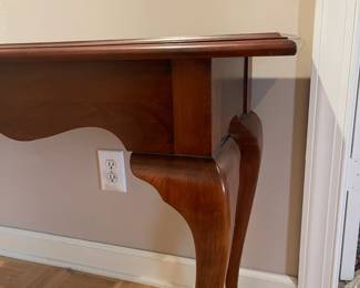 F94 - $125. Knob Creek Entry Table - Solid wood in very good condition. Was covered by a runner and has a 1" stripe down the front that looks like sun fading. Otherwise great condition - very sturdy! Measures 56" x 17" x 27" tall. 