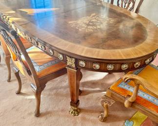 A beautiful neoclassical dining table with a beige/brown/white marble top, wood base, and porcelain and brass ormolu mounts, circa