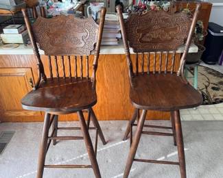 Pair of oak pressed back swivel bar stools