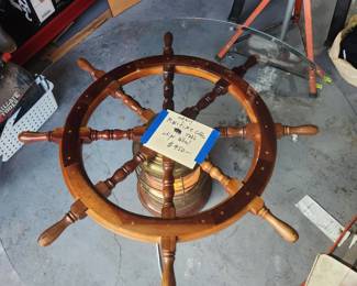 This coffee table could easily be separated in the three pieces, he shifts wheel was drilled out in the middle and fit on top of the maritime light, then a glass top. The light underneath the table is beautiful