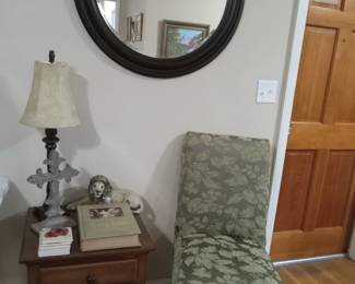 Side table, slipper chair, lamp, decor, Bible, framed round mirror