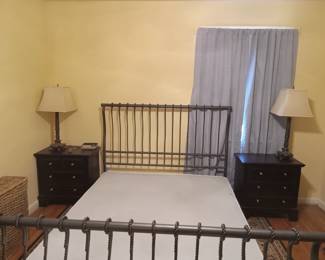 Metal king bed has box springs, no mattress.  Matching nightstands with a pair of lamps.
