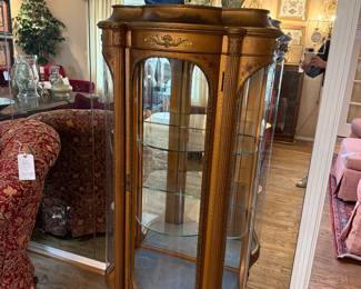 Curved glass curio cabinet with beautiful details