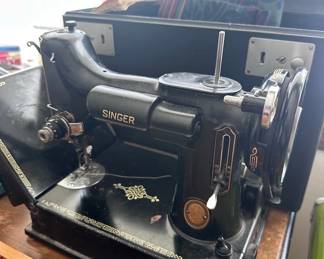 Vintage Singer sewing machine with table and attachments