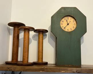 Vintage industrial wooden bobbins or spools and primitive wooden mantel clock