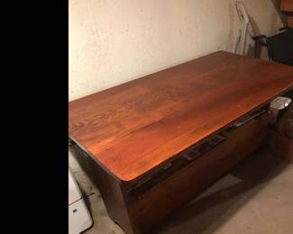 In  the lower level is this cool table, but wait it turns into a bench with storage!