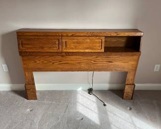 Queen Bed has storage headboard which slide from side to side