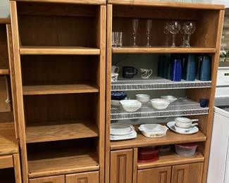 Two different open faced storage units with cupboards beneath