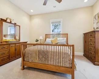 This queen bedroom set includes bed, mattress, box spring, long dresser w/attached triple mirror, tall dresser, bedside table, and second tall dresser (not shown) - $875.