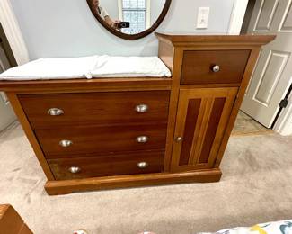 Changing table with three large drawers, one small drawer and cupboard storage $50
