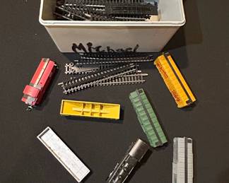 Assorted Model Train Cars and Track Pieces
