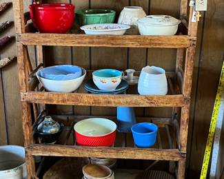 Tons of serving bowls and wooden shoe rack! 