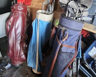 Three Vintage Golf Bags with Assorted Clubs