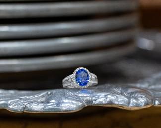 Platinum Tanzanite & Diamond Ring Striking oval tanzanite surrounded by brilliant diamonds in a platinum setting. Elegant estate piece with vivid color and exceptional sparkle.