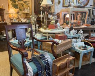 beautiful arm chair, vintage ties, sweet vintage wall shelf, blue side table, lamps, large scale pretty wall hangings