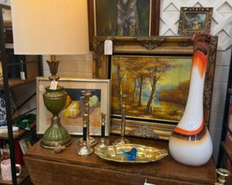 vintage green and gold large table lamp, framed oils, barley twist table that folds up for use as a side table or can be used opened to seat those extra dinner guest, brass candlesticks, floral trivet, books, candlesticks of all kinds