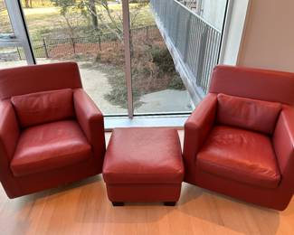 Pair of Roche Bobois leather swivel chairs and ottoman