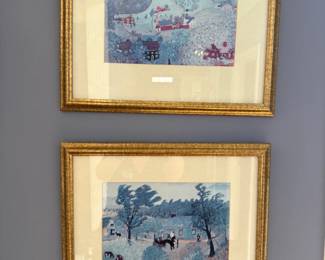 Pair of Grandma Moses style folk art prints, winter village scenes, gold gilt frames