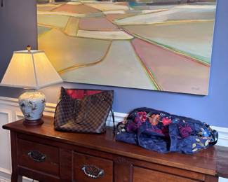 Dark wood sideboard and landscape painting