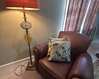 Leather club chair with decorative pillows