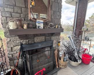 Stone outdoor fireplace with rustic mirror