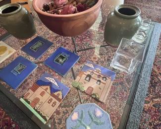 Glass coffee table with pottery and decor