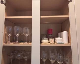 Crystal stemware and candles in cabinet