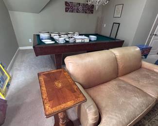 Pool table, leather sofa, inlaid burl wood pedestal side table, crystal chandelier